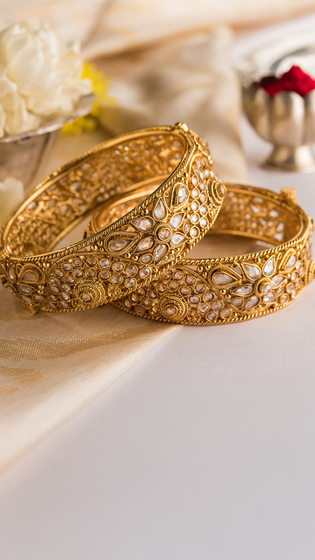 A pair of gold designer bangles for bride 